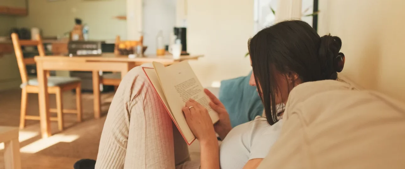 relaxed-woman-reading-book-on-a-comfortable-couch-2026-01-05